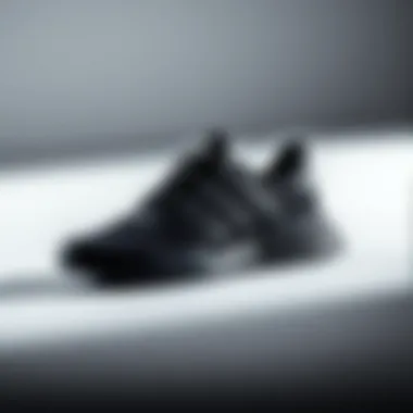 The Essence of Elegance in Adidas Black Sports Shoes Elegant black Adidas sports shoes on a minimalist background