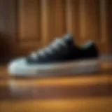 Iconic Design of Converse Chuck 70 Plus Stylish black and white Converse Chuck 70 Plus sneakers on a wooden floor