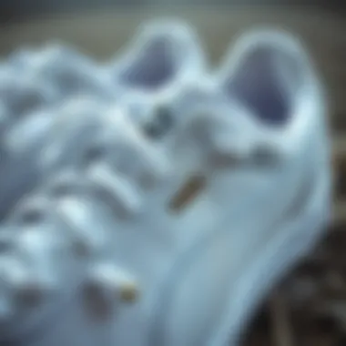 Close-up of Puma white sneakers showcasing design details